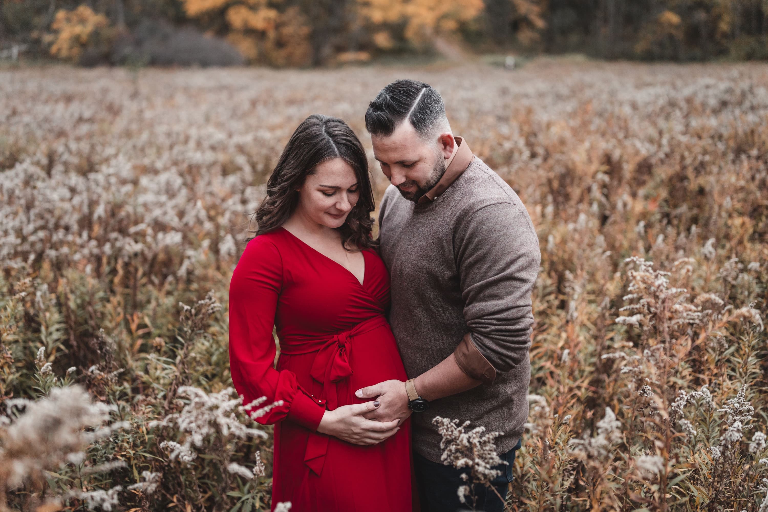 Husband and wife embracing during their maternity session at Pincess Point in Hamilton Ontario.