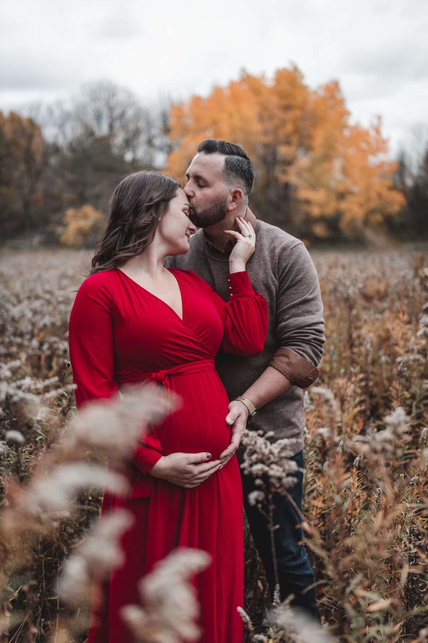 Husband and wife embracing during their maternity session at Pincess Point in Hamilton Ontario.