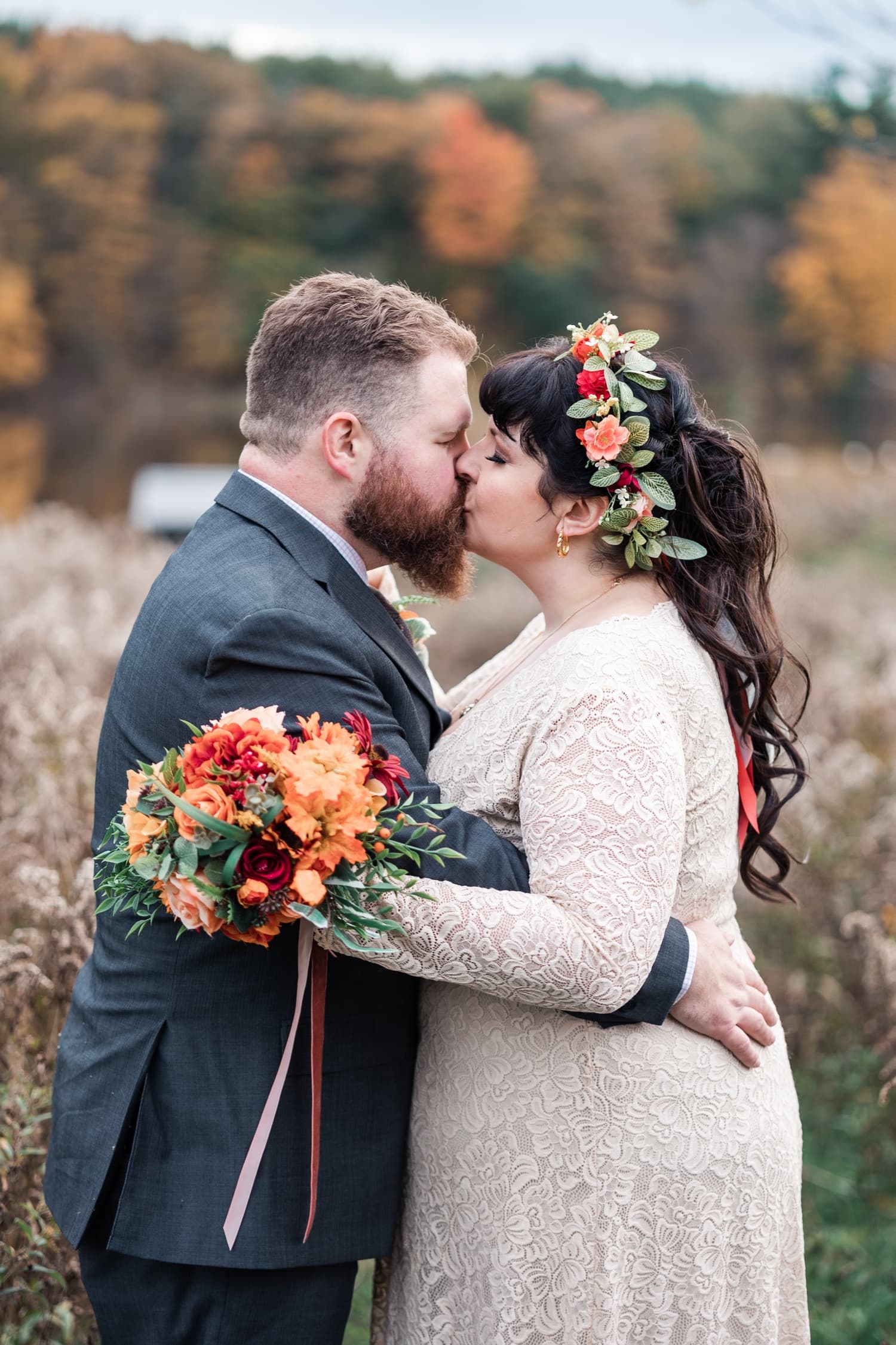 Wedding couple embracing in a field during golden hour at Christie Lake In Hamilton Ontario.